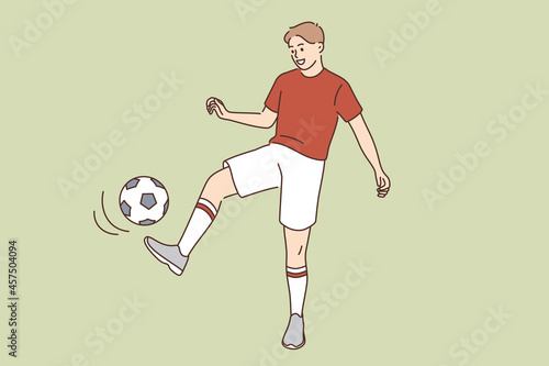 Fototapeta Naklejka Na Ścianę i Meble -  Sport hobby and active lifestyle concept. Young smiling man boy cartoon character kicking ball playing soccer in sportswear vector illustration 