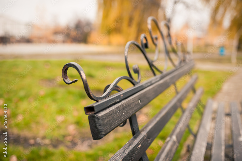 Wooden bench in autumn park. Autumn outdoor relax. Wooden bench in autumn park. Autumn outdoor relax.