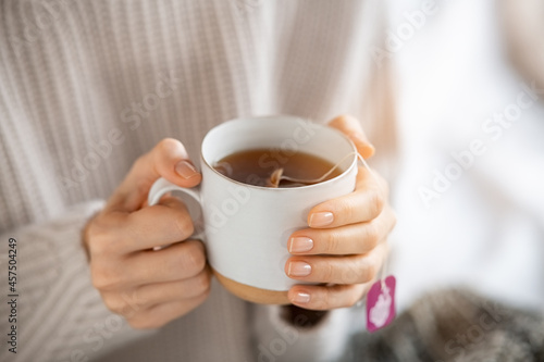Woman holding hot tea cup
