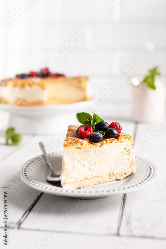 Vanilla cheesecake decorated with berries on a plate photo