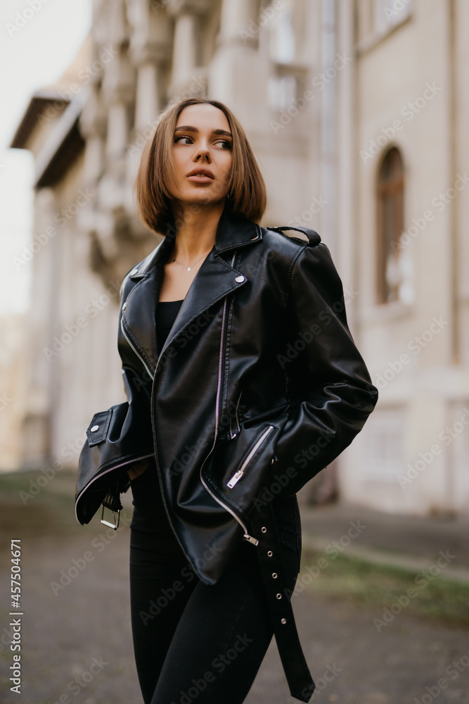 Young girl in leather jacket and jeans resting outdoors. portrait of ...