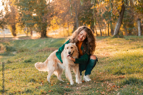 White Retriever dog receives a reward for obedience outdoors