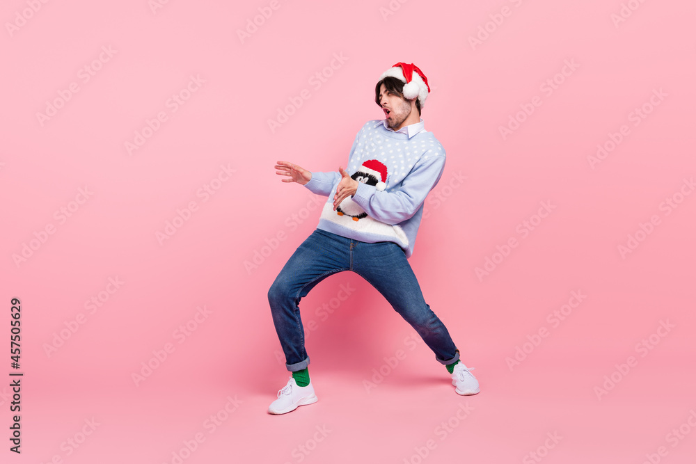 Photo of pretty attractive young man dressed blue christmas pullover dancing riding horse smiling isolated pink color background