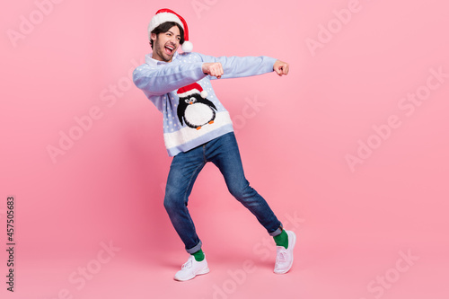 Photo of funky handsome gentleman wear new year sweater smiling dancing isolated pink color background