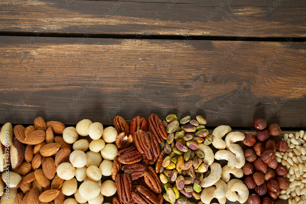 assortments of nuts on wooden surface assortments of nuts on wooden surface