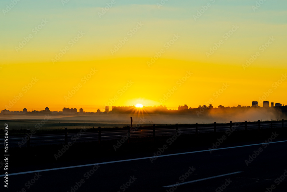 city. sunrise sun. expressway. fog. close-up. there is a tinting.