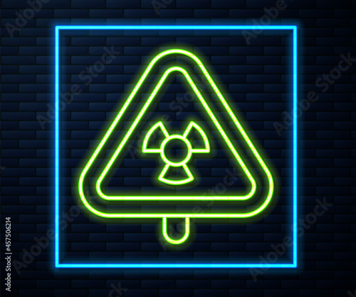 Glowing neon line Triangle sign with radiation symbol icon isolated on brick wall background. Vector
