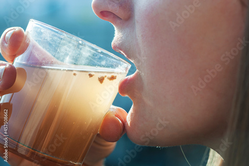 Woman is drinking dirty water from the glass cup