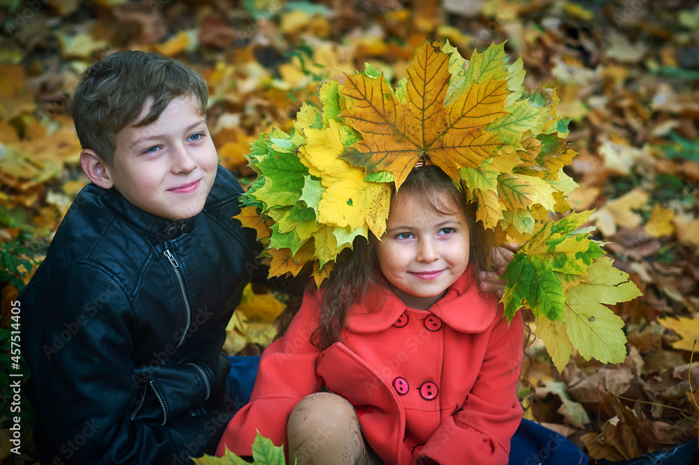 Portrait of children in the autumn park . Brother and sister on a walk . Portrait of children in the autumn park . Brother and sister on a walk .