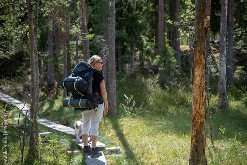 Woman hiking in forest with backpack
