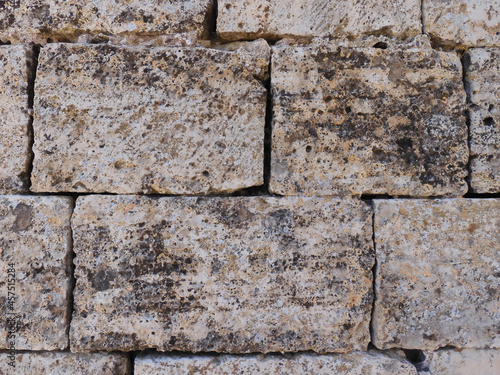 Detail of the old stone wall of an ancient Romanesque church