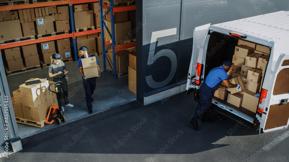 © Gorodenkoff - Outside of Logistics Distributions Warehouse with Diverse Team of Professional Workers Loading Delivery Truck with Cardboard Boxes, Online Orders, Purchases, E-Commerce Goods. High Angle Shot