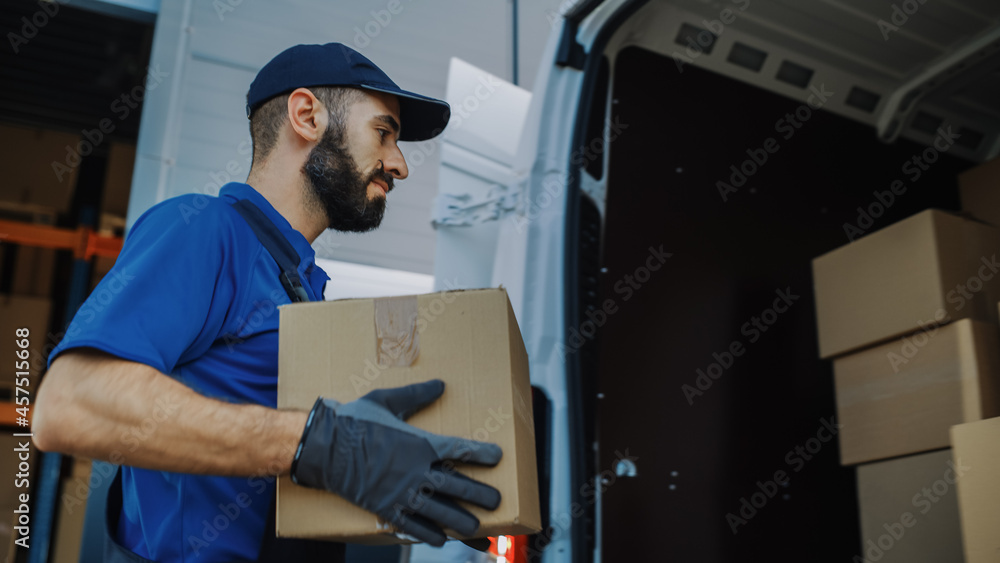 Handsome Latin Male Worker Walks Out of Warehouse Carry Cardboard Box and Loads it into Delivery Truck. Logistics Distribution Center, Delivering e-Commerce Online Orders. Handsome Latin Male Worker Walks Out of Warehouse Carry Cardboard Box and Loads it into Delivery Truck. Logistics Distribution Center, Delivering e-Commerce Online Orders.