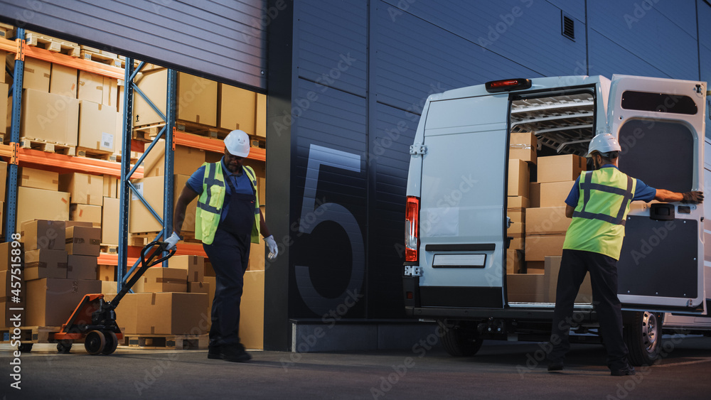 Fototapeta premium Logistics Warehouse Two Happy Workers Talk, Joke use Hand Pallet Truck Start Loading Delivery Truck with Cardboard Boxes, Online Orders, Purchases, E-Commerce Goods.