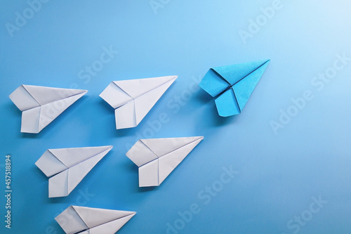 blue paper plane is leadership among white paper plane