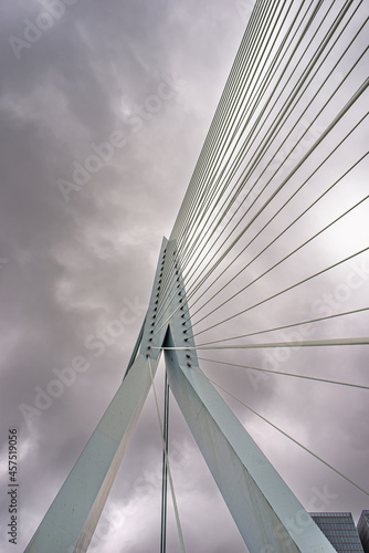 15 September 2021, Rotterdam . South Holland, Netherlands, Fragment of the Erasmus Bridge over the the Nieuwe Maas (New Meuse) River on cloudy day..