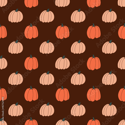 Seamless pattern with pumpkins on a brown background for Halloween. Hand drawn vector illustration. Ornament for printing on fabric, wallpaper, wrapping paper, clothing