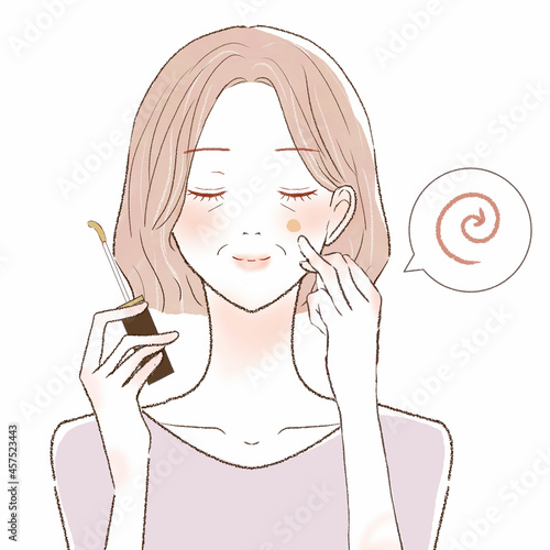 コンシーラーを顔に塗って、指で馴染ませる中年女性