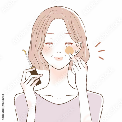 コンシーラーを顔に塗る中年女性