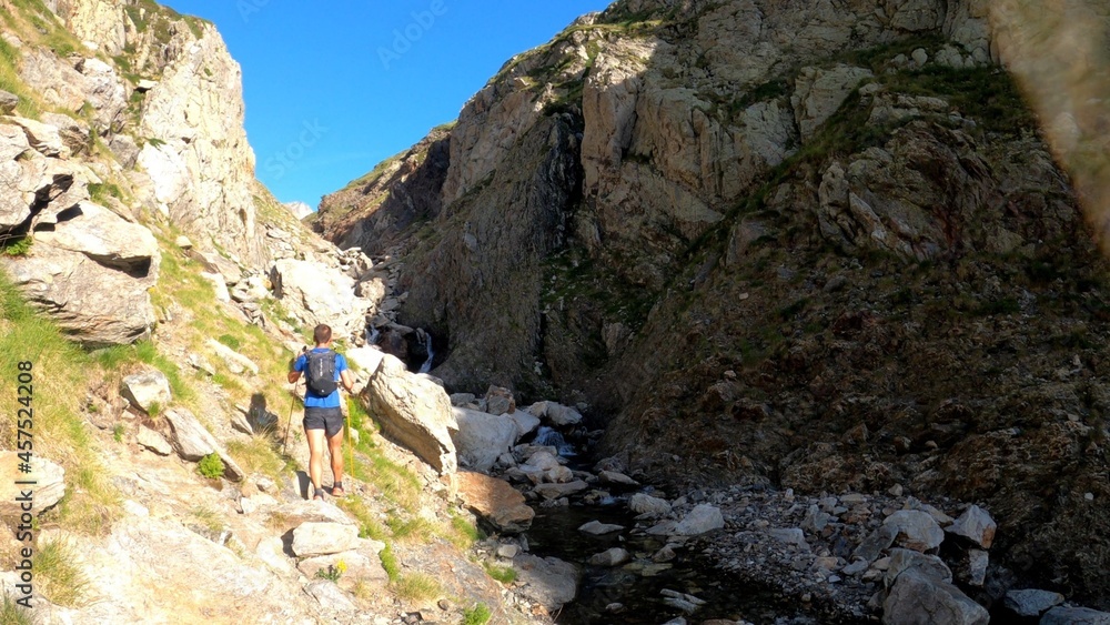 young man hiking in the mountains young man hiking in the mountains