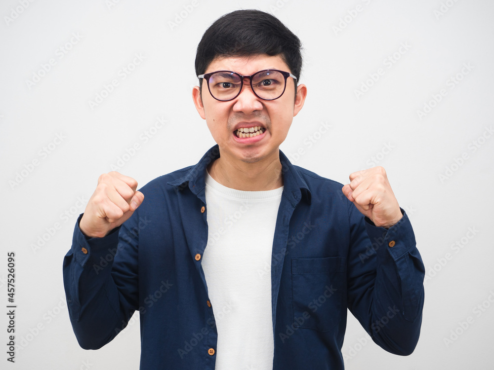 Angry man wearing glasses show fist up portrait white background Angry man wearing glasses show fist up portrait white background