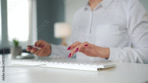 Wallpaper Mural Woman typing credit card number on computer keyboard. She making online purchase. Online payment service. Torontodigital.ca