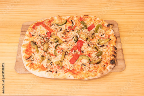 Rectangular Vegetable Pizza with Roasted Red Bell Pepper, Green Bell Pepper, Zucchini and Mushrooms Topped with Mozzarella Cheese and Tomato