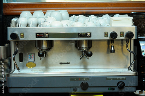 Coffee station. Coffee machine plates and cups set on a table in restaurant