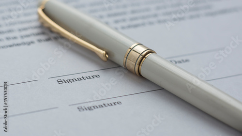 pen over a document to be signed. 