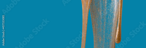 wide banner with gold slime with glitter on a blue background abstract minimalism