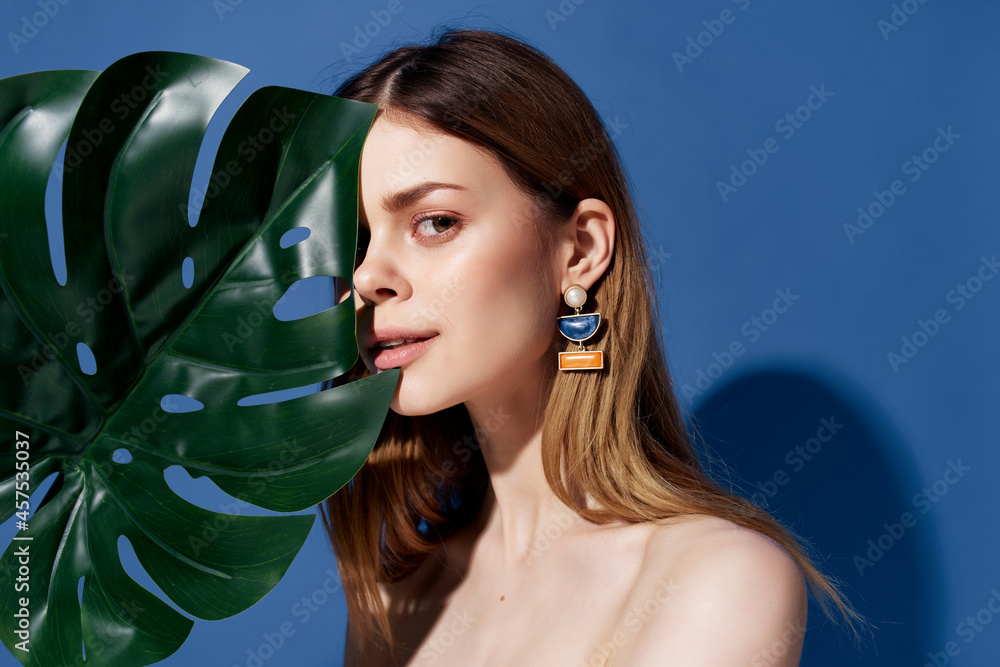 beautiful woman green palm leaf posing blue background beautiful woman green palm leaf posing blue background