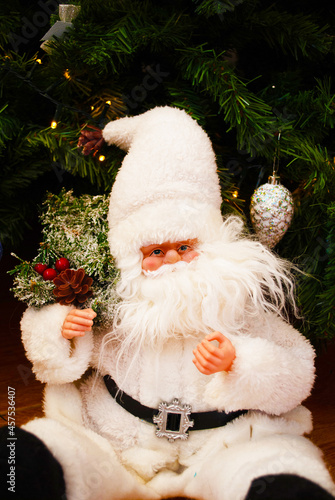 Santa claus under the christmas tree, bokeh, background, toys, merry christmas, happy new year. 2022. Lights, sparkles and glare, snow, Christmas decor, toys