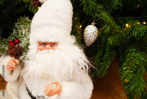 Santa claus under the christmas tree, bokeh, background, toys, merry christmas, happy new year. 2022. Lights, sparkles and glare, snow, Christmas decor, toys