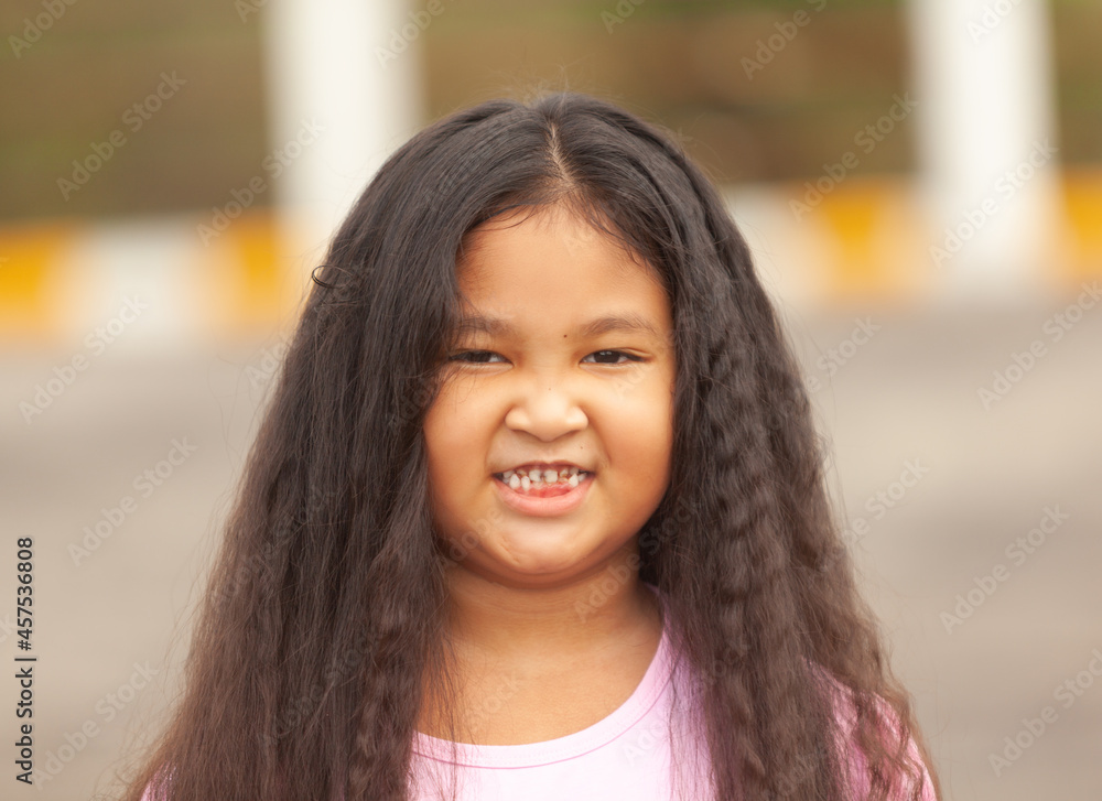 Asian girl smiles to see decayed teeth and baby teeth falling out. Asian girl smiles to see decayed teeth and baby teeth falling out.