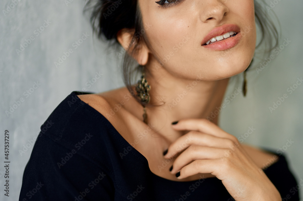 Woman in black dress basing earrings jewelry model