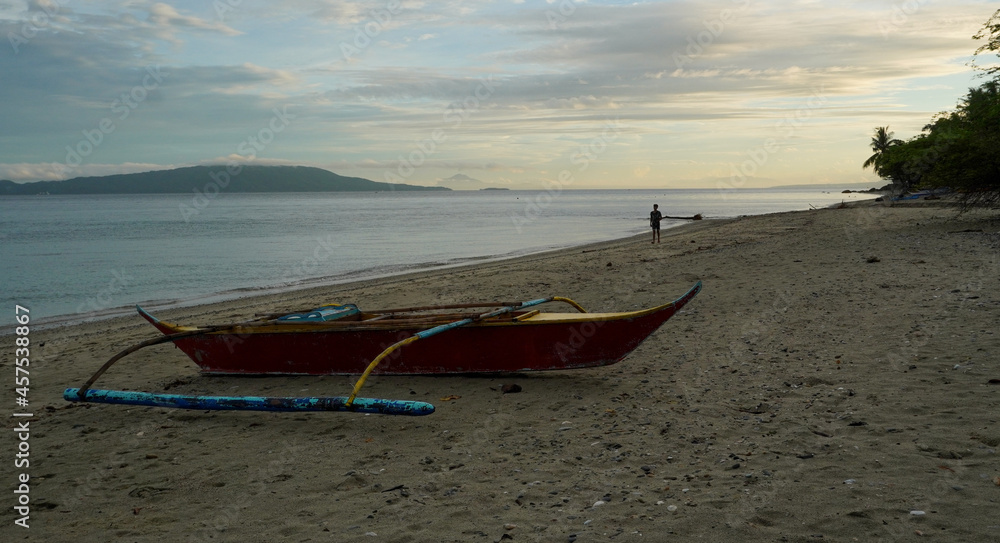 Sunrise at Aninuan beach. This is a tourist beach with no tourists. Only the fishing banka boats and a few locals are out early. 