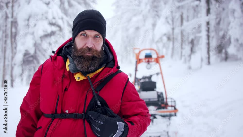 Paramedic man from mountain rescue service with walkie talkie outdoors in winter in forest. Paramedic man from mountain rescue service with walkie talkie outdoors in winter in forest.