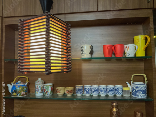 Canvas Print Colorful bone china ans ceramic cups and mugs with designs on them displayed nea