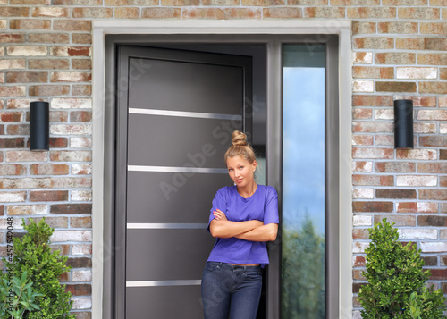 Beautiful woman opening the door of her home.