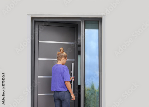 Beautiful woman opening the door of her home. © lado2016