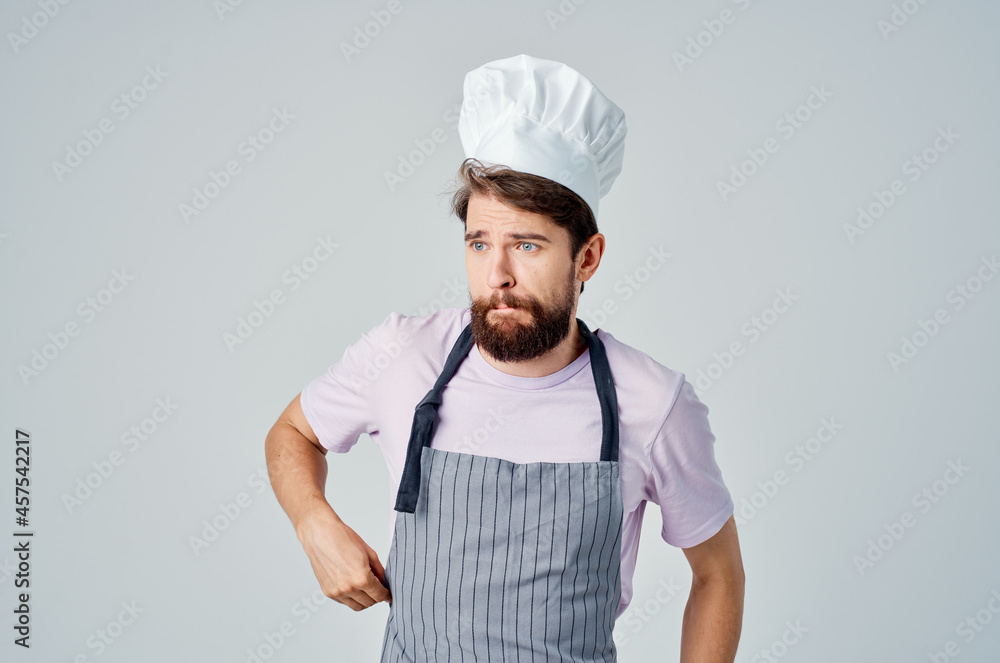 emotional bearded man in apron working in the kitchen providing services emotional bearded man in apron working in the kitchen providing services