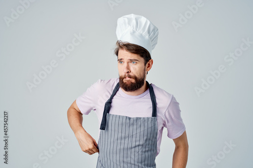 emotional bearded man in apron working in the kitchen providing services