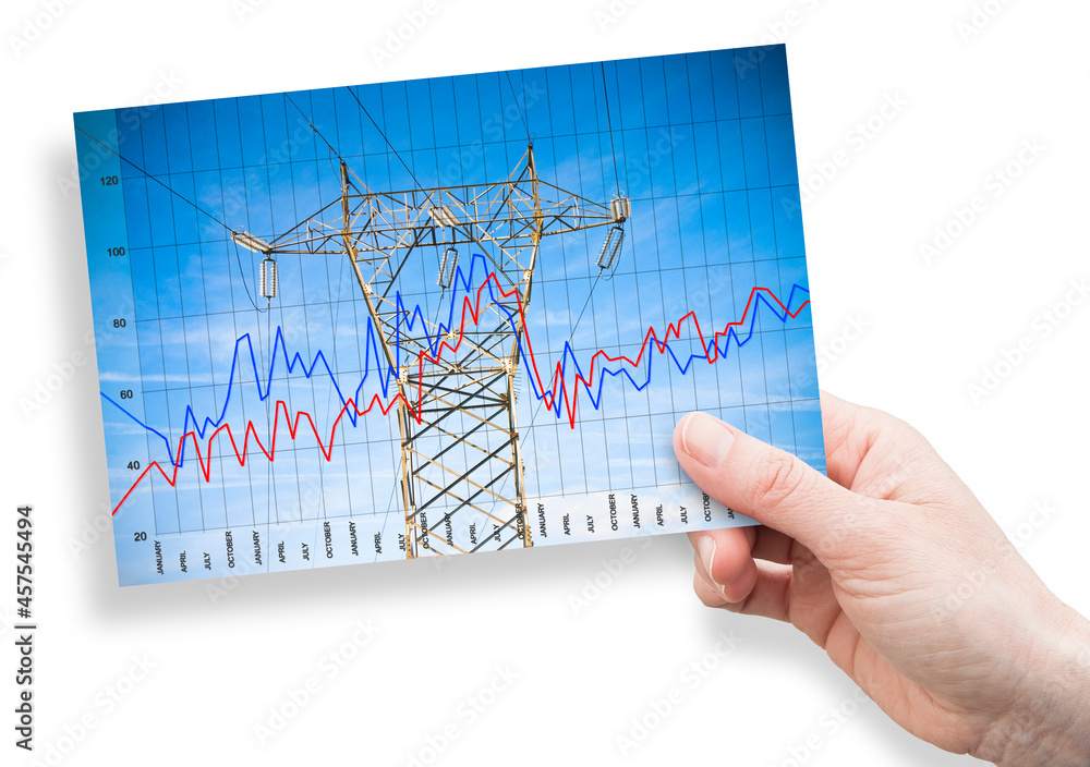 Graph about energy production - concept image with power tower and transmission lines on sky background - Concept with hand holding an postcard Graph about energy production - concept image with power tower and transmission lines on sky background - Concept with hand holding an postcard