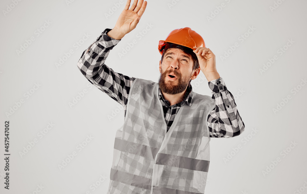 emotional man in orange hard hat construction professional light background emotional man in orange hard hat construction professional light background