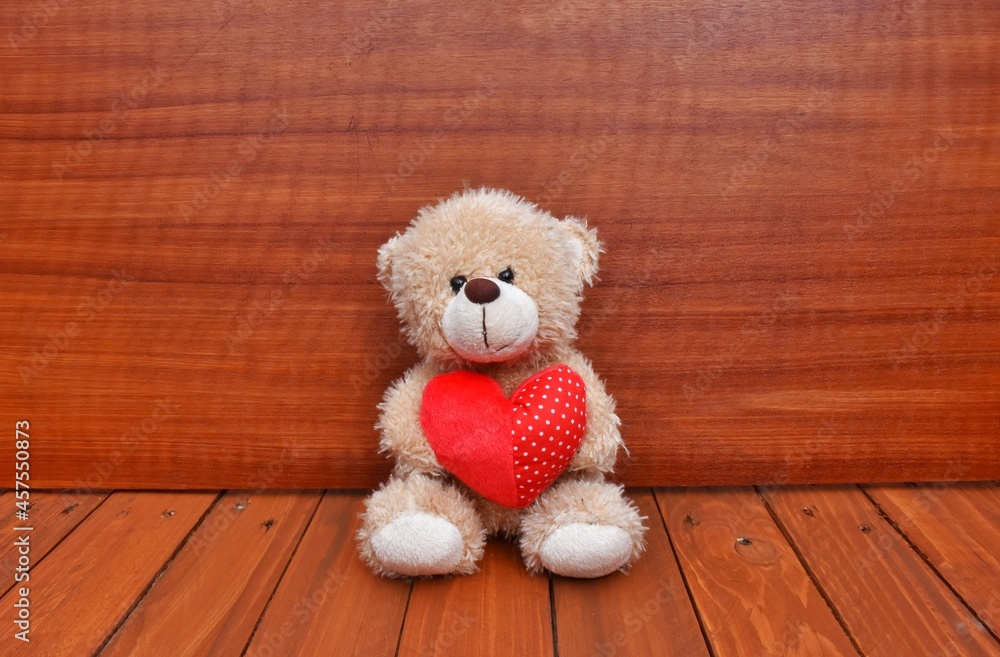 Obraz premium A small teddy bear with red heart. Valentine's day 