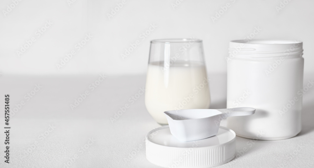 collagen peptides powder in a white unbranded container and glass with protein drink. collagen for beautiful skin and healthy joints. natural supplement for beauty care, copy space. collagen peptides powder in a white unbranded container and glass with protein drink. collagen for beautiful skin and healthy joints. natural supplement for beauty care, copy space.