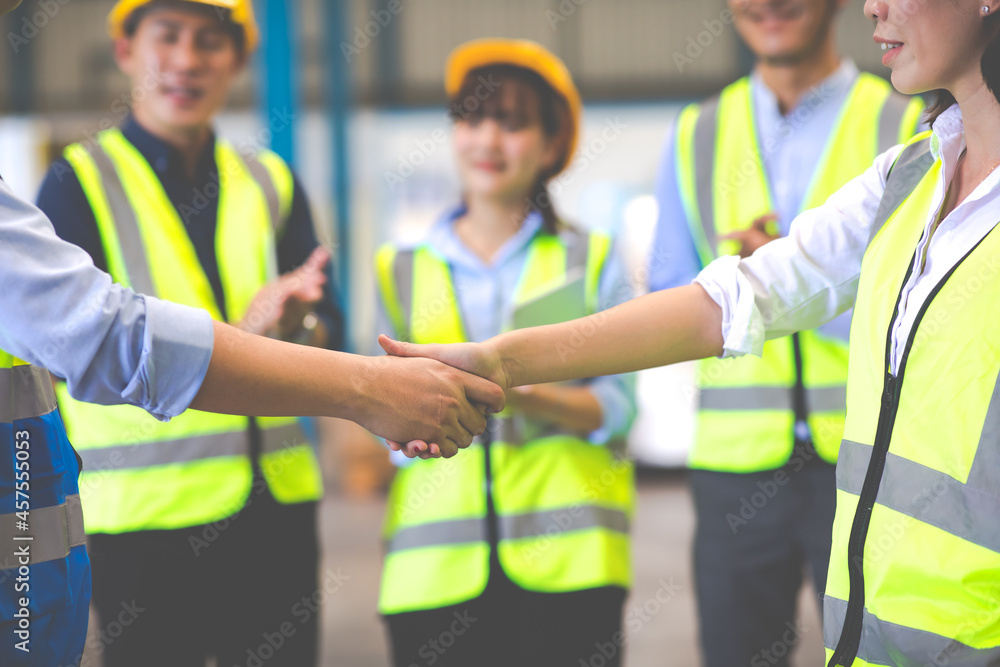 Handshake. Engineering man shaking hand with professional engineer team at warehouse. Handshake. Engineering man shaking hand with professional engineer team at warehouse.