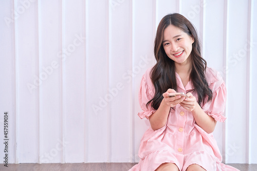 Happy woman use phone and smile at home