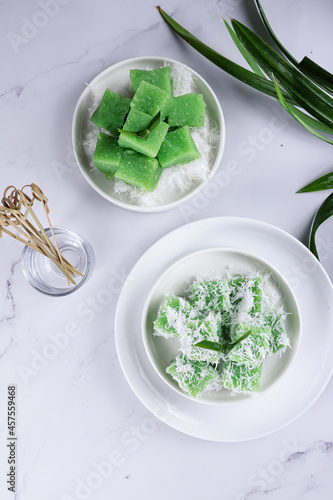 Ongol ongol pandan. Indonesia traditional cake that made from sweet potatoes. It's steamed and wraped with grated coconut after cooked. photo