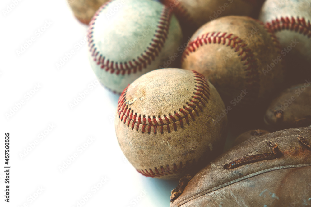 Old leather baseball glove with used balls from game with copy space on white background. Old leather baseball glove with used balls from game with copy space on white background.